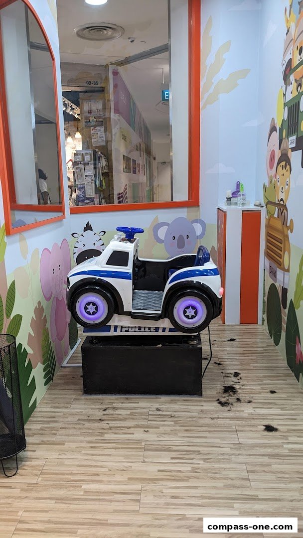 A police car-themed chair for children in a brightly decorated salon.
