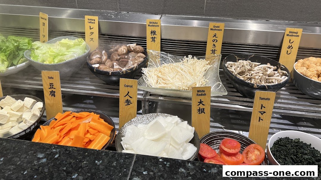A variety of fresh ingredients for hot pot, including vegetables and mushrooms, displayed for self-service.