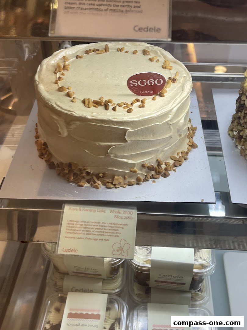 A close-up of a Cedele Kaya & Kacang Cake with a description card.