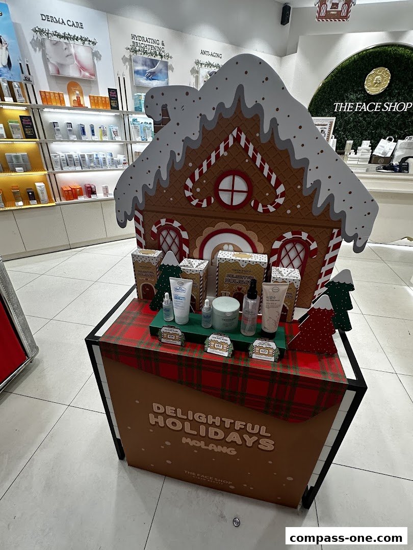 A festive holiday display featuring skincare products from The Face Shop, shaped like a gingerbread house.