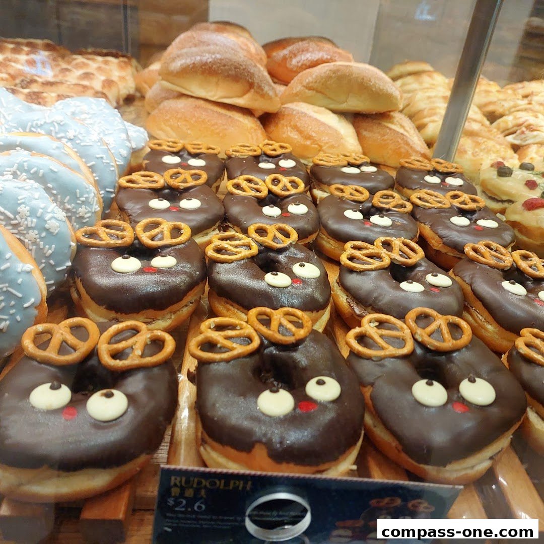 A display of freshly baked donuts and bread, featuring festive Rudolph-themed donuts.