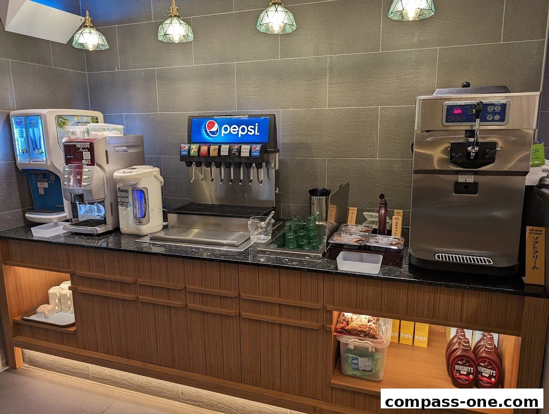 Beverage and soft serve ice cream station with coffee and soda dispensers.