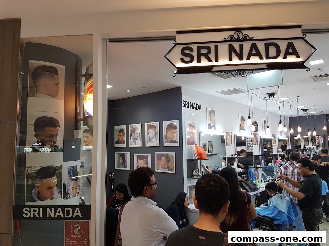 The entrance and interior of Sri Nada Hairdressing Salon, showcasing hairstyles and barbers at work.