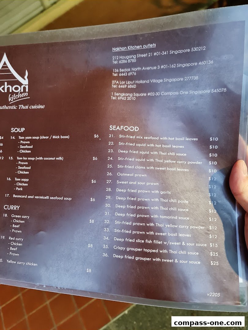 A menu from Nakhon Kitchen showing Thai dishes like soups, curries, and seafood with prices.