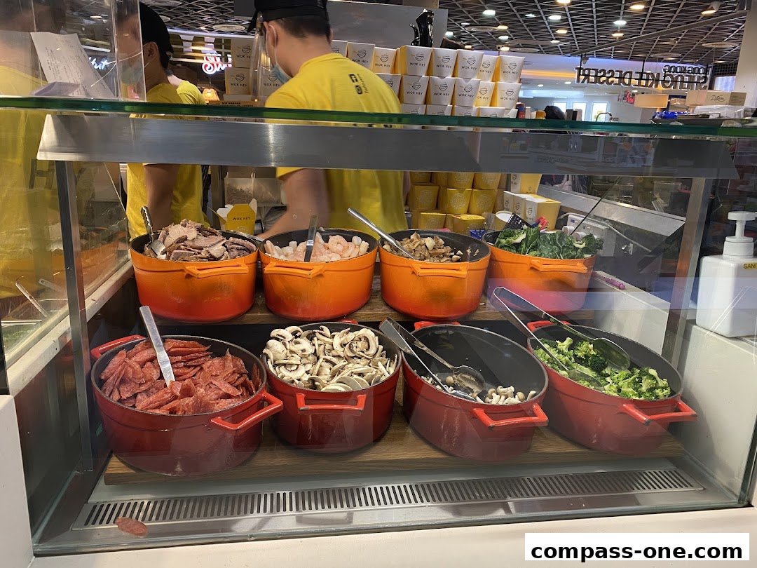 A display of fresh ingredients for stir-fry at Wok Hey, including meats, seafood, and vegetables.
