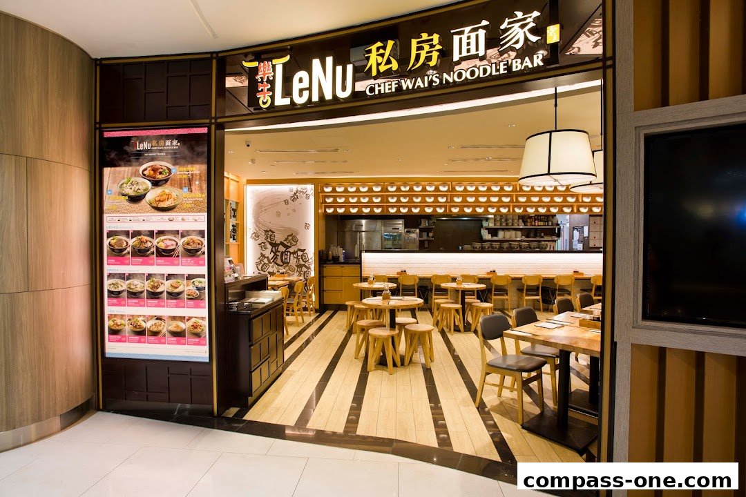 The inviting entrance of LeNu Chef Wai's Noodle Bar, showcasing its modern interior and menu display.