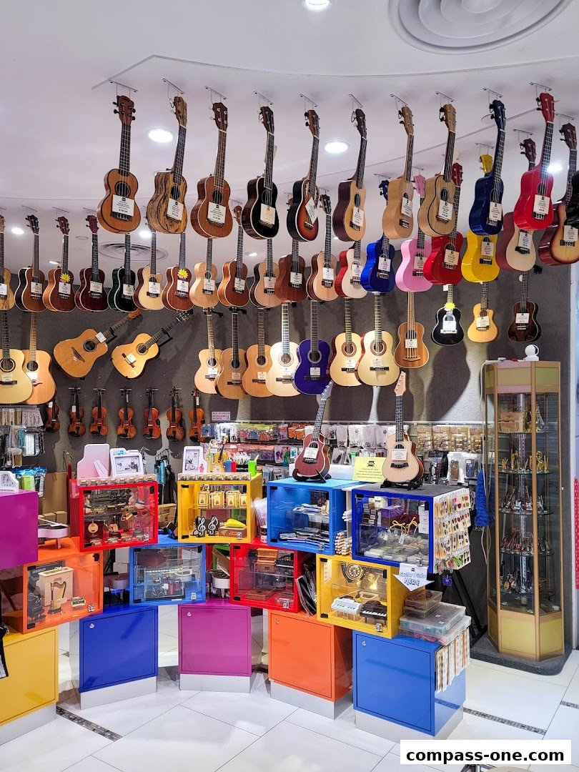 A vibrant display of ukuleles and guitars hanging from the ceiling and on colorful shelves.