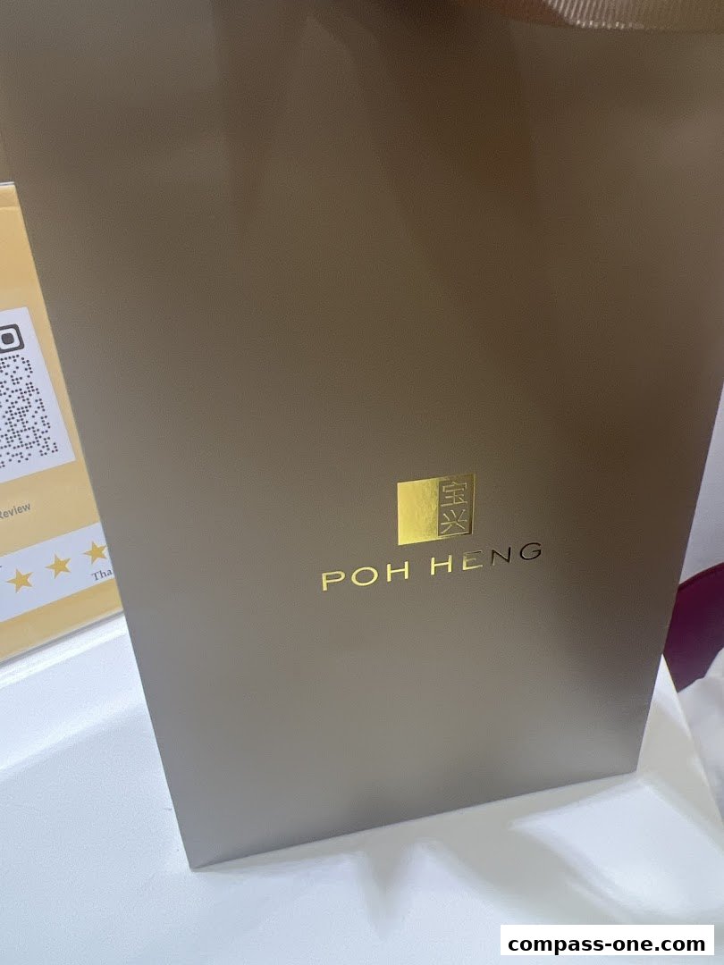 A close-up of a Poh Heng Jewellery shopping bag with its logo prominently displayed.