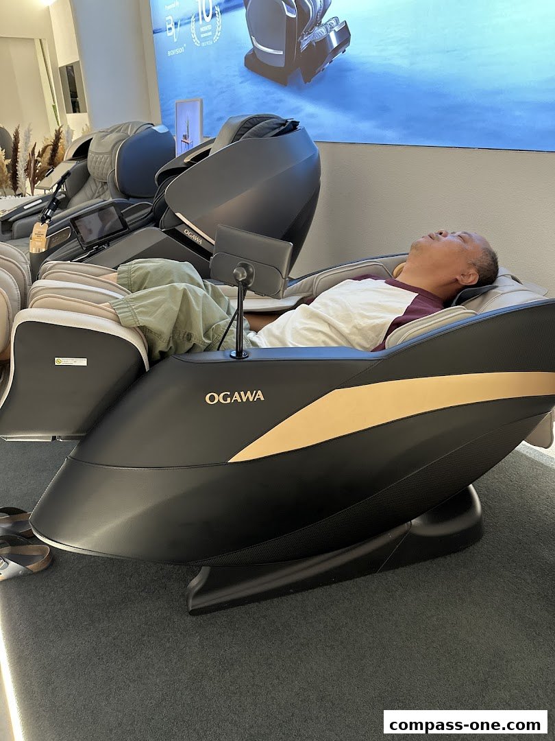 A man relaxes in a luxurious OGAWA massage chair, experiencing ultimate comfort.