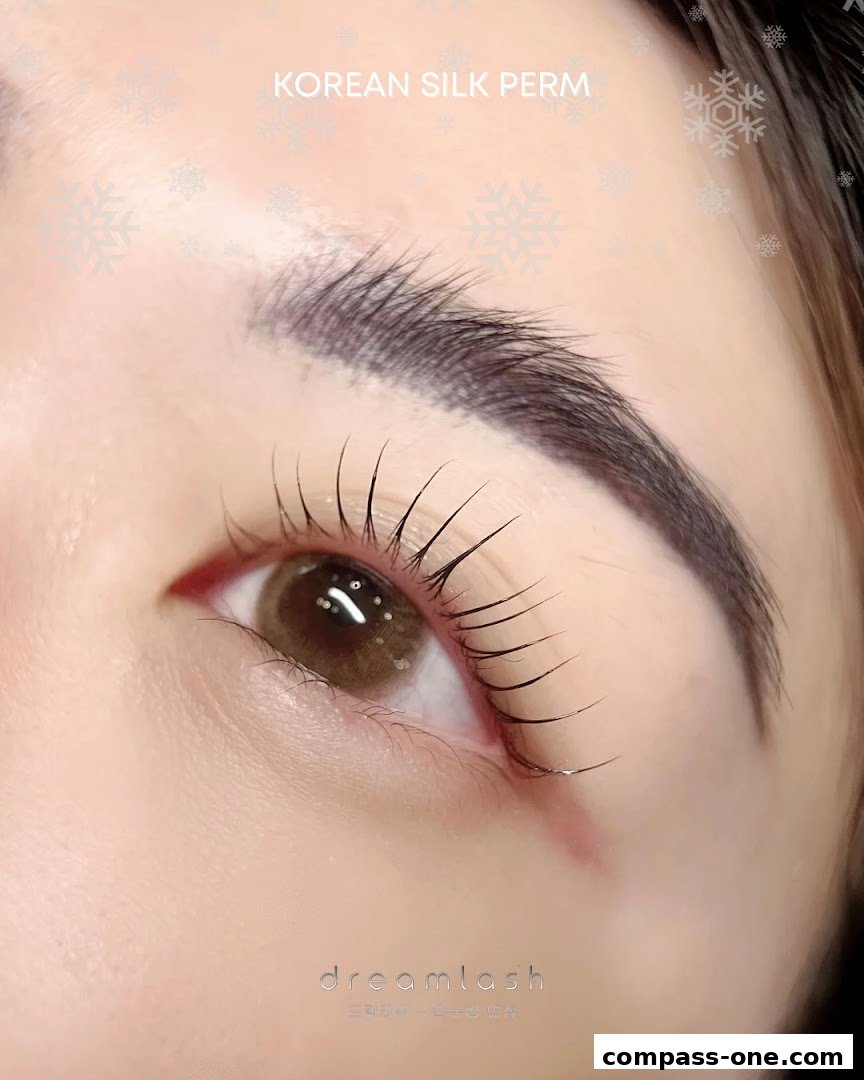 Close-up of a woman's eye showcasing perfectly curled lashes after a Korean Silk Perm treatment.