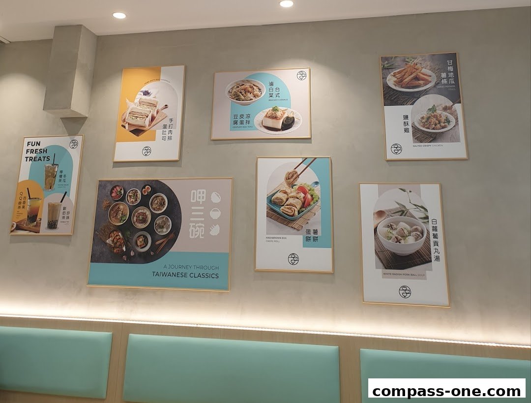 A wall display showcasing various Taiwanese dishes and drinks offered at Eat 3 Bowls.