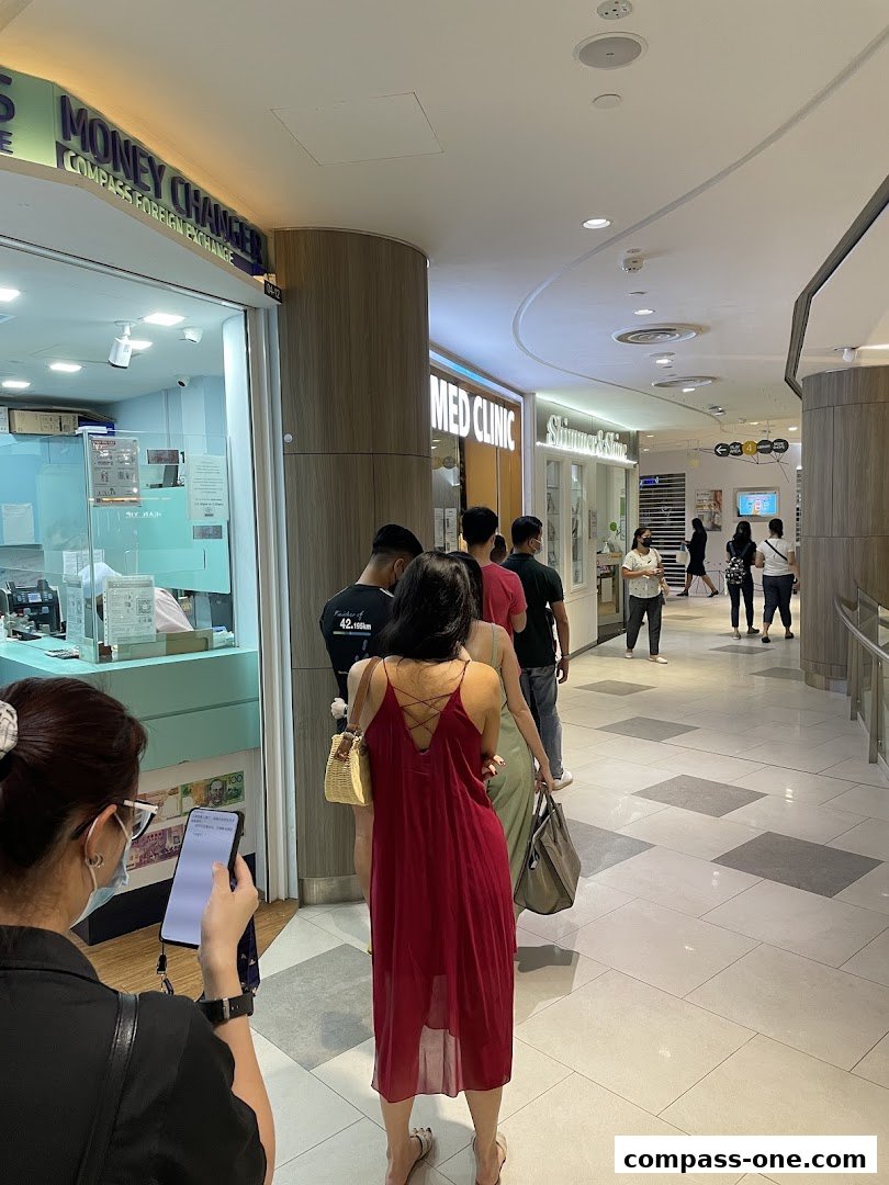 People queuing outside Minmed Clinic and a money changer in a shopping mall.