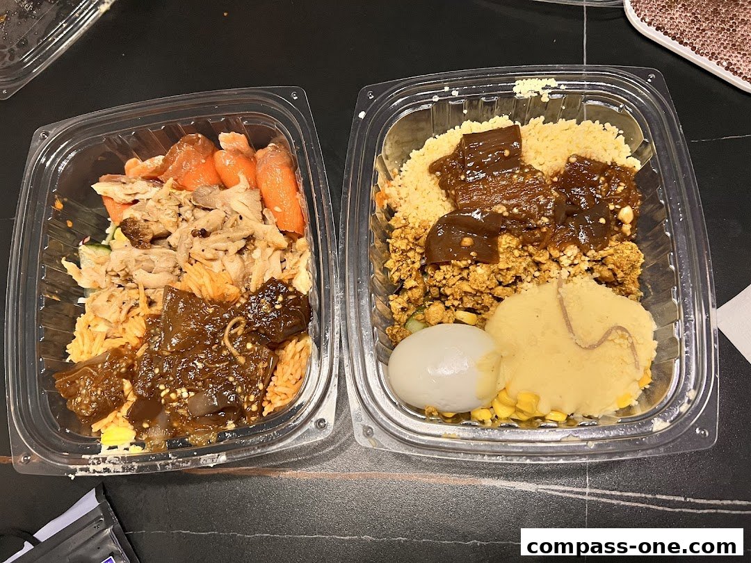 Two takeout containers filled with various food items, including rice, meat, vegetables, and a hard-boiled egg.