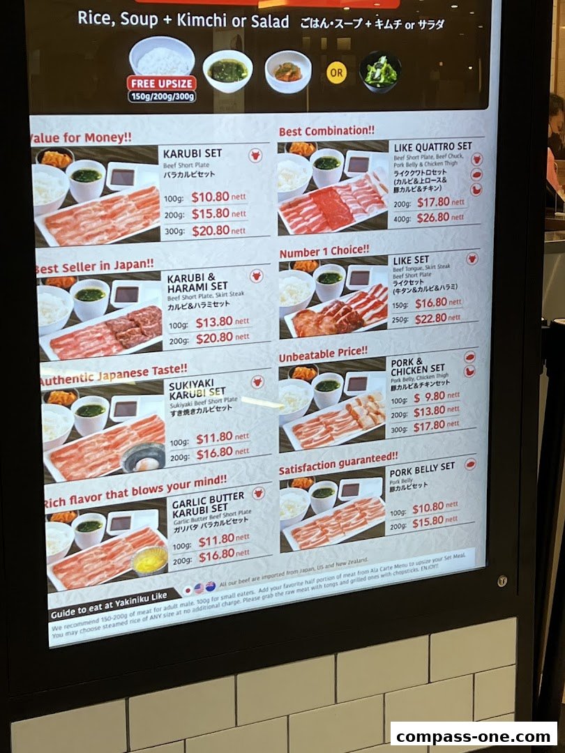 A digital menu board displaying various Yakiniku sets with prices and descriptions.