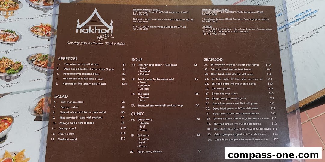 A menu from Nakhon Kitchen, featuring authentic Thai cuisine with various categories like appetizers, salads, soups, curries, and seafood dishes.