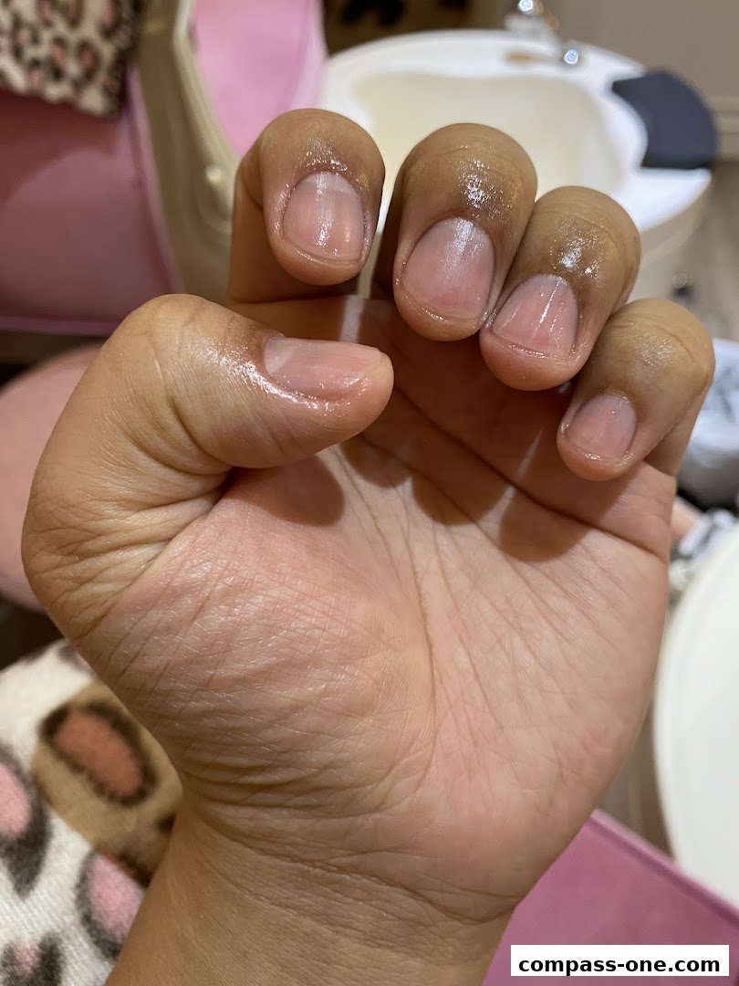 Close-up of a hand with freshly manicured, natural-looking nails.