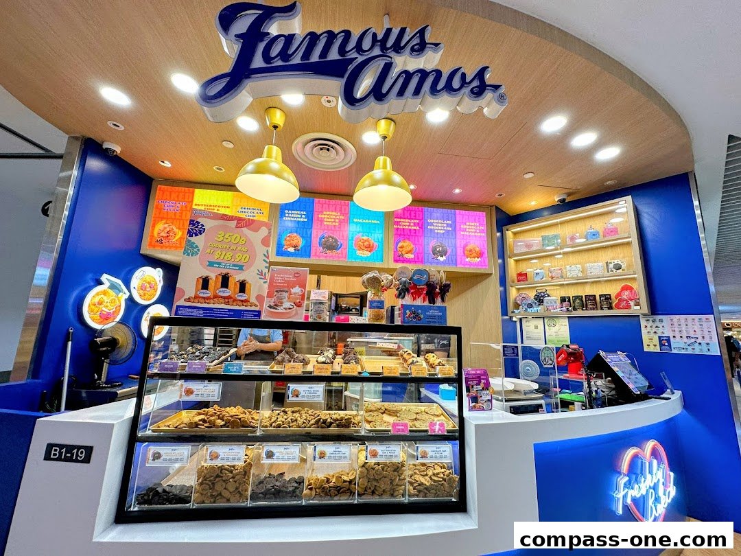 A Famous Amos cookie store counter displaying various cookie flavors and gift boxes.