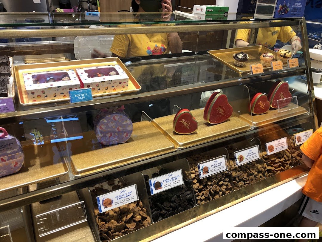 A display case filled with various cookies and heart-shaped gift boxes from Famous Amos.