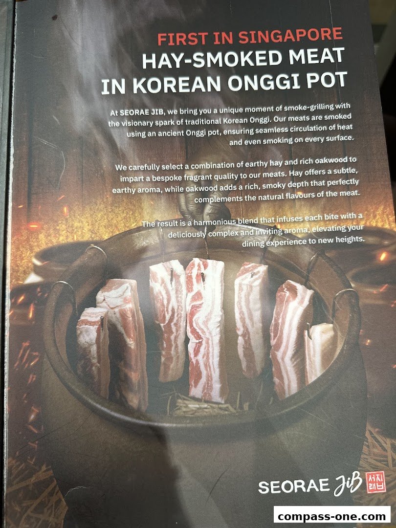 A close-up of raw meat being smoked in a traditional Korean Onggi pot.
