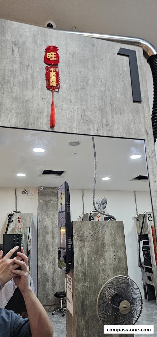 Interior of a modern hair salon with concrete walls, mirrors, and styling stations.