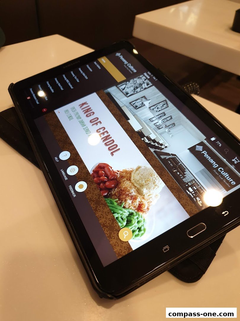 A tablet displaying the Penang Culture website with a featured dish.