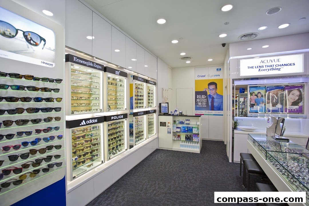 Interior of an optical shop showcasing a wide selection of sunglasses and eyeglasses from various brands.