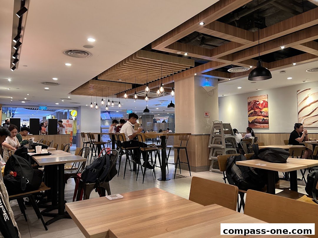 Interior view of a Burger King restaurant with customers dining at tables.