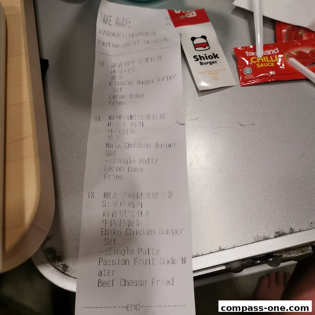 A receipt from Shiok Burger detailing takeaway orders including burgers, fries, and drinks.