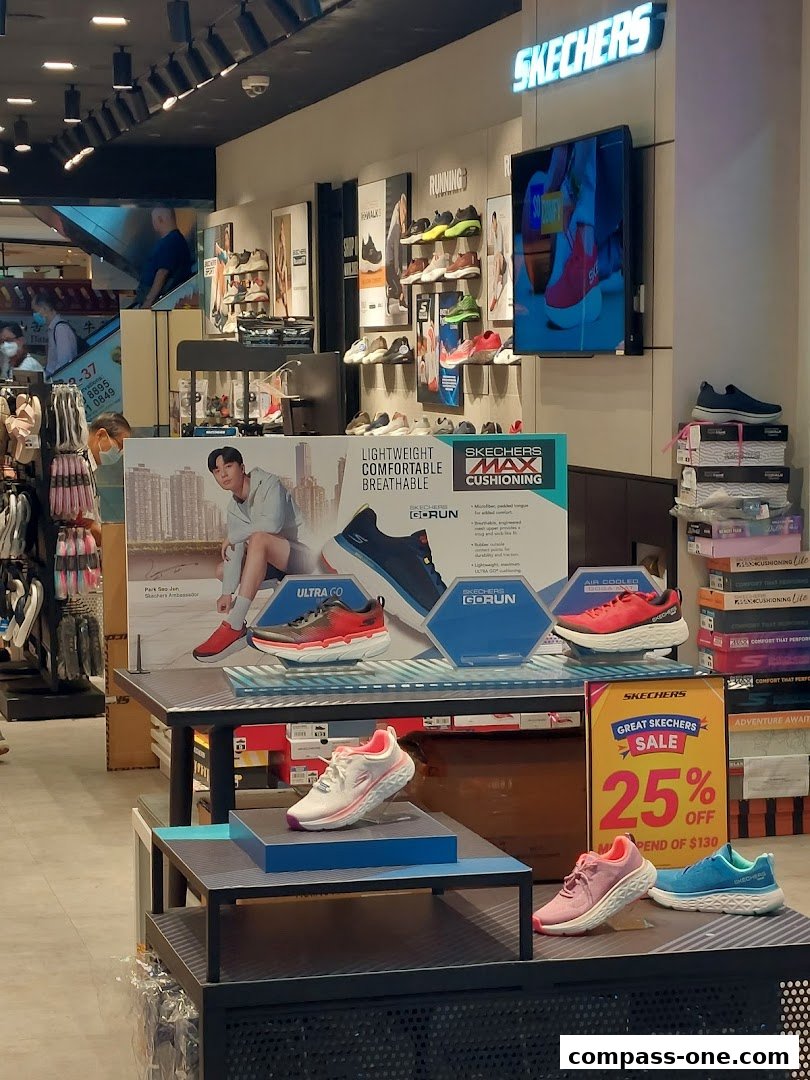 Interior view of a Skechers store showcasing various athletic shoes and a sale promotion.