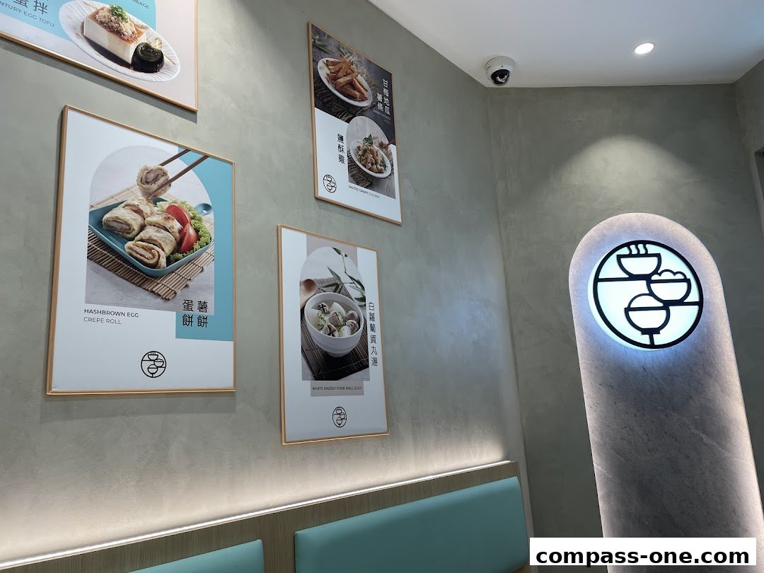 Interior view of a restaurant with food posters and a glowing logo.