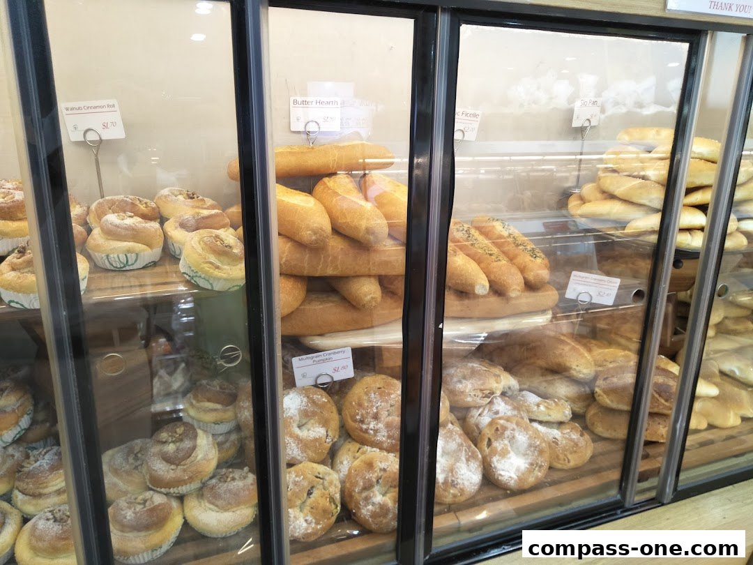 A display case filled with various freshly baked breads and pastries from Four Leaves.