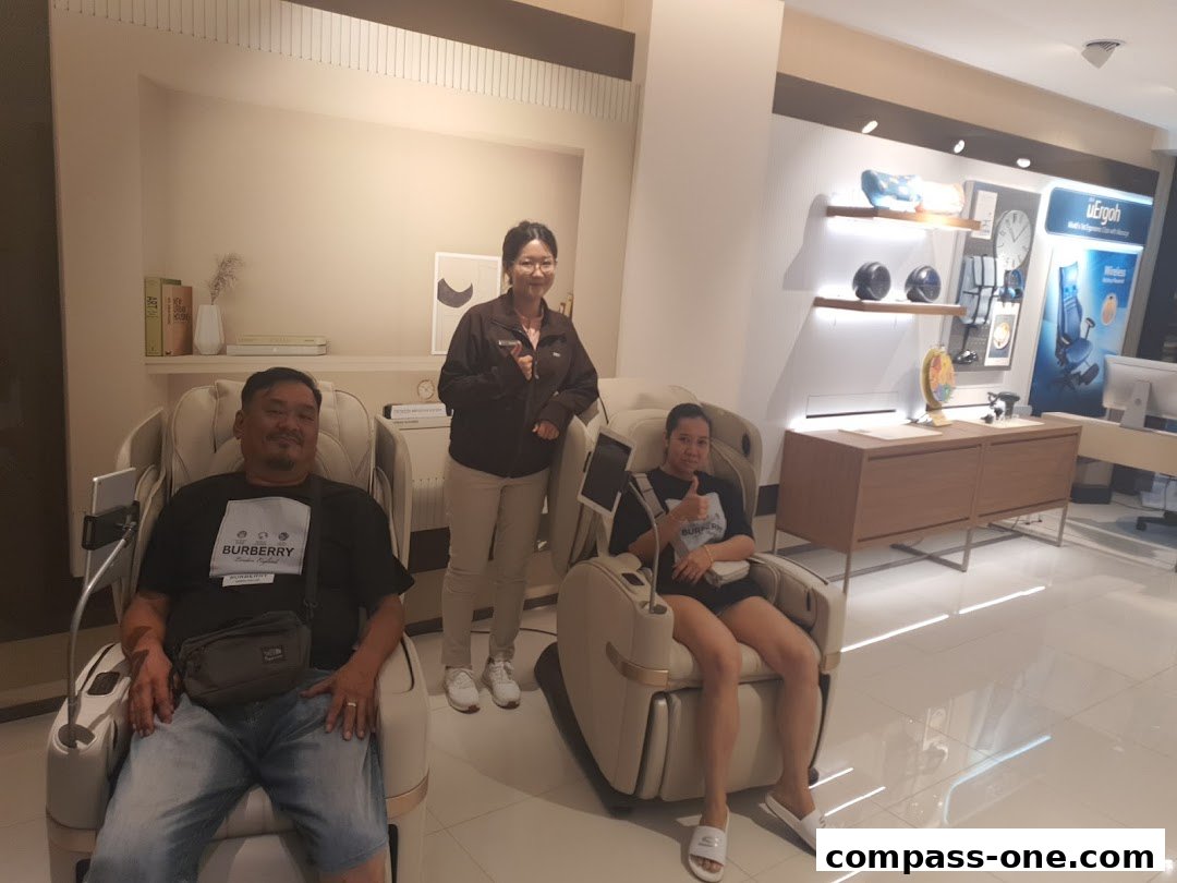 People trying out massage chairs in a modern retail store.