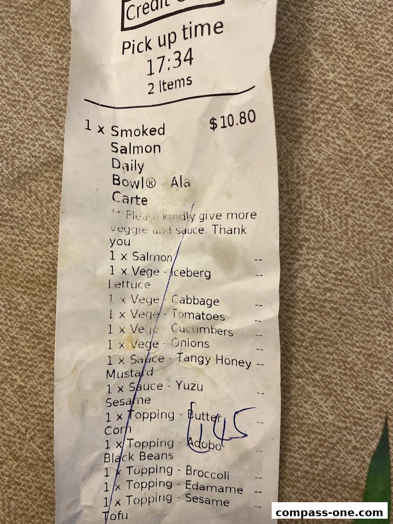 A receipt detailing a Smoked Salmon Daily Bowl order with various toppings and vegetables.