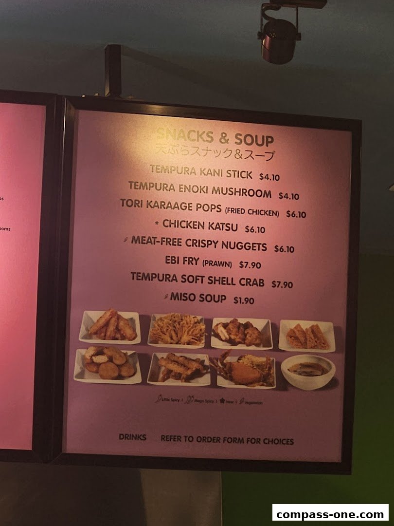 A menu board displaying snacks and soup items with prices and images.