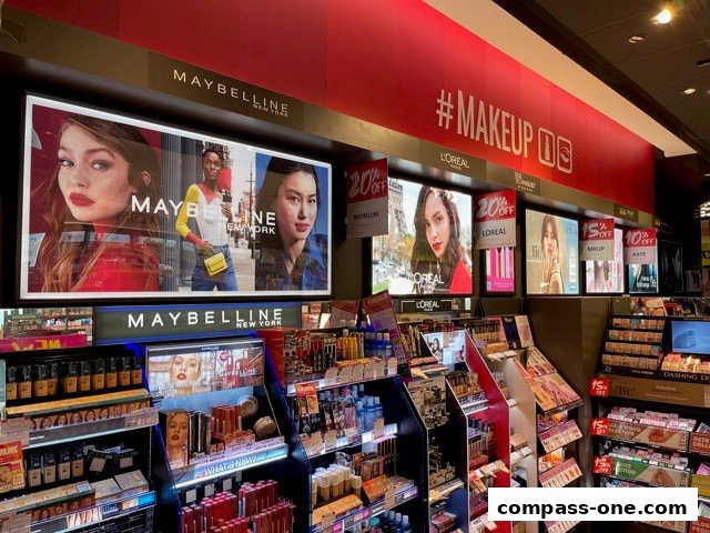 Interior view of a makeup store featuring Maybelline and L'Oréal products and promotions.