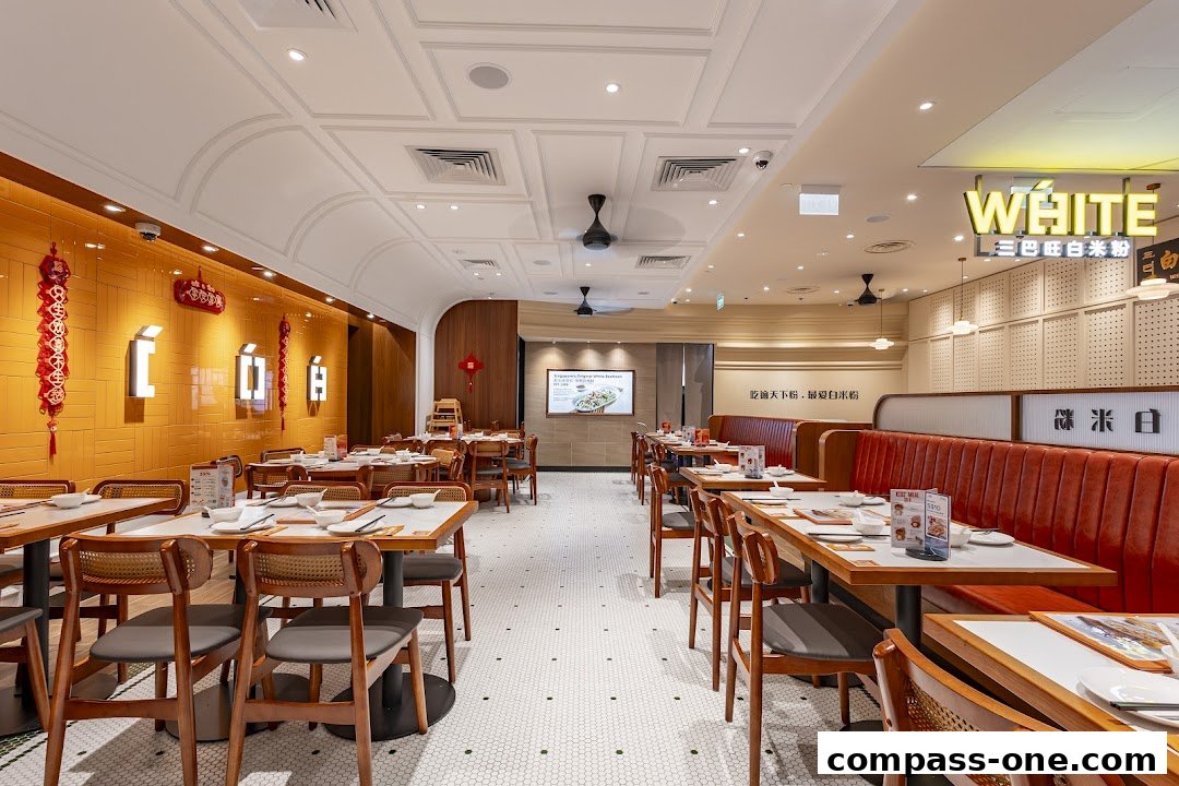 Interior view of a brightly lit restaurant with orange walls and wooden furniture.