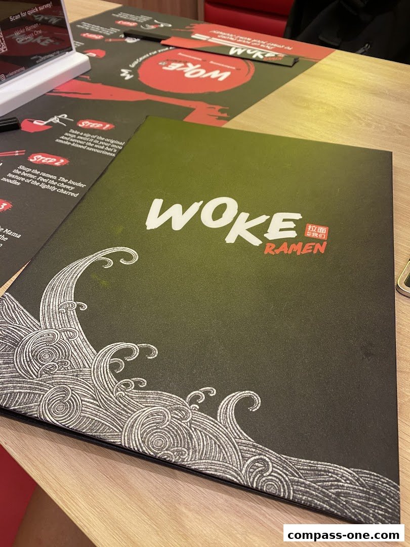 A Woke Ramen menu with a wave design and instructions on how to enjoy the ramen.