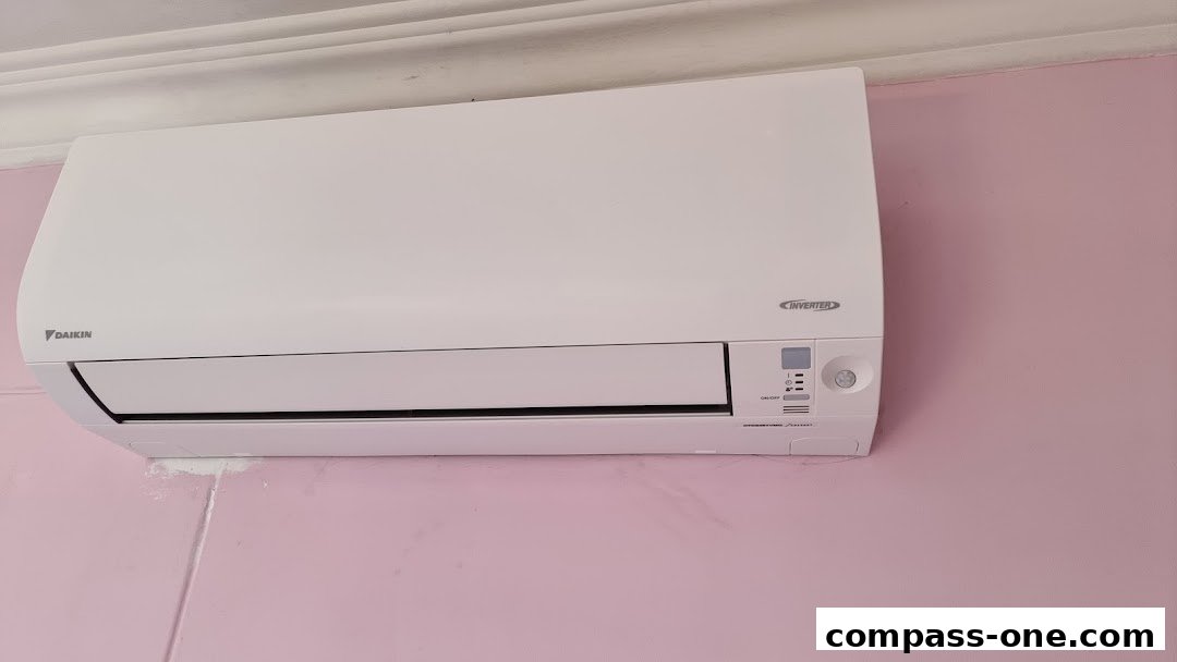 A Daikin inverter air conditioner unit mounted on a pink wall.