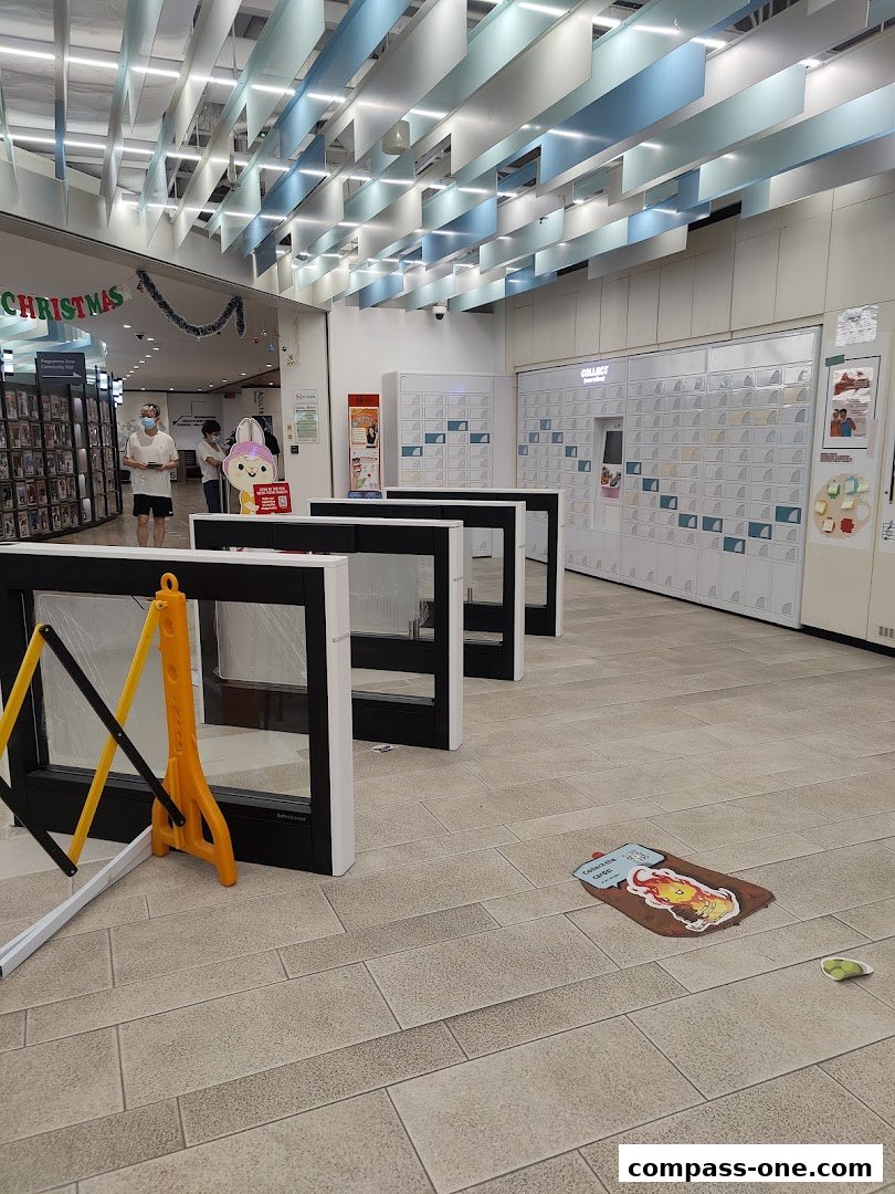 Interior view of a public library with lockers and a Christmas decoration.