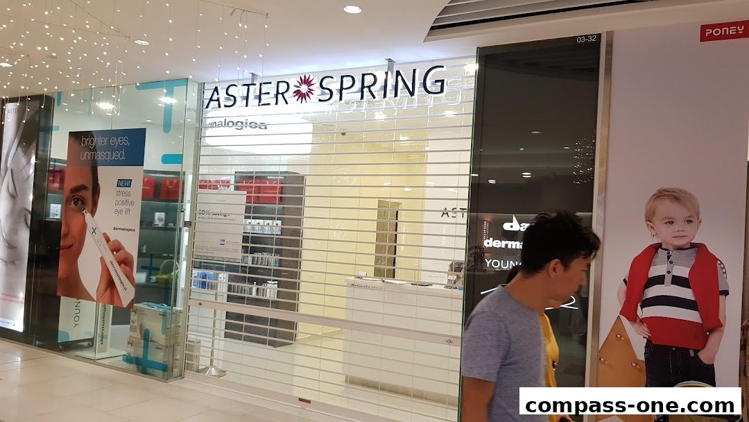 The AsterSpring shop front with its logo, promotional posters, and a closed roller shutter.