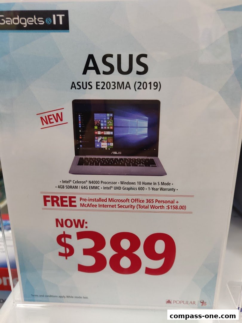 A promotional sign for an ASUS laptop with its specifications and price.