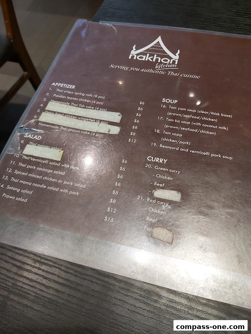 A menu from Nakhon Kitchen featuring Thai appetizers, salads, soups, and curries.