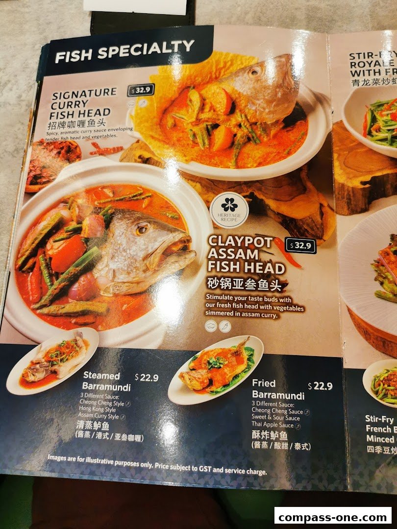A menu page showcasing various fish dishes, including curry fish head and steamed barramundi.