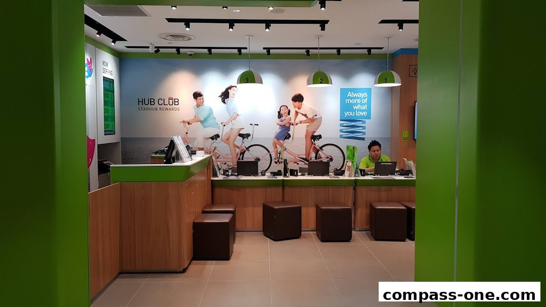 Interior of a StarHub shop with staff at the counter and promotional graphics.