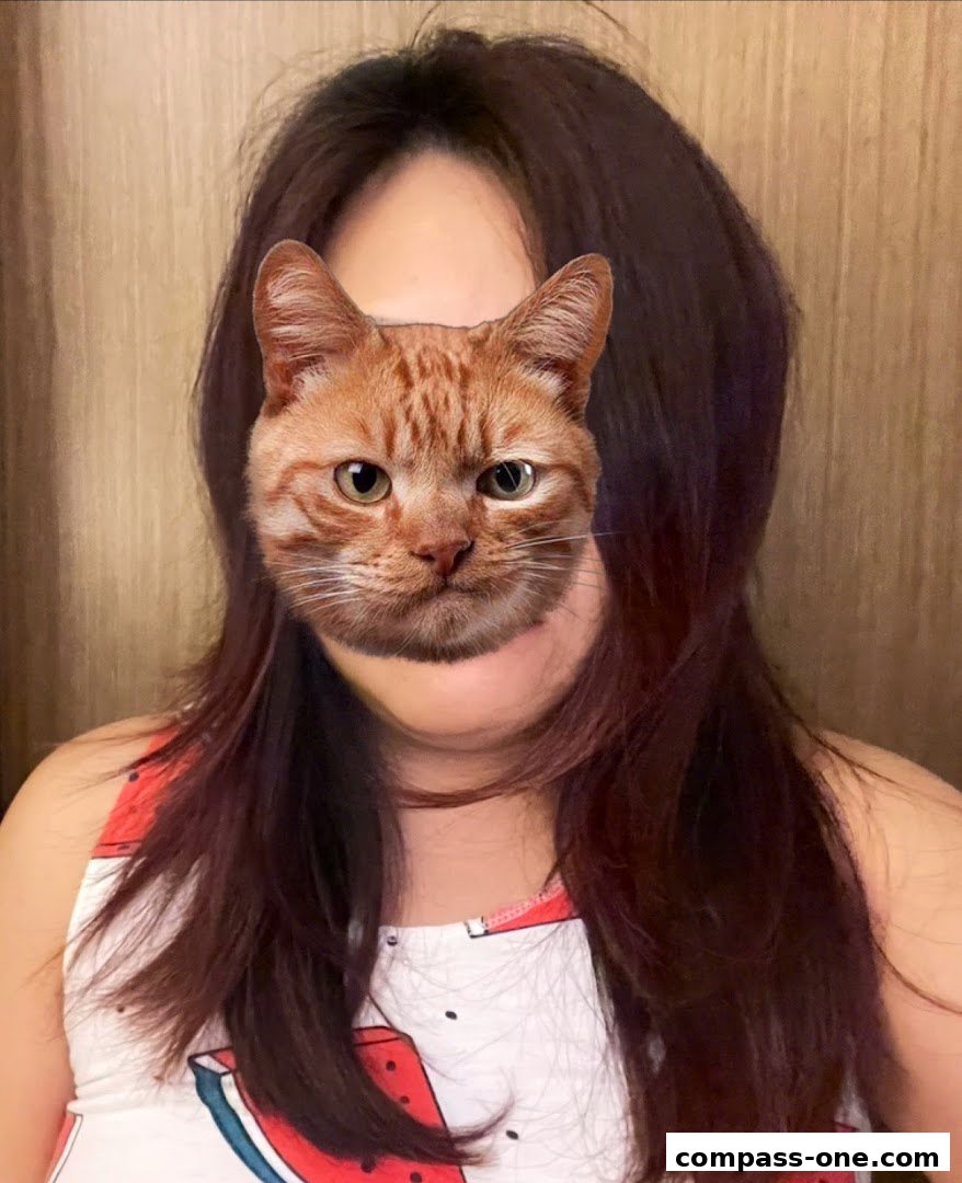 A person with a cat face filter superimposed over their face, wearing a watermelon-themed top.