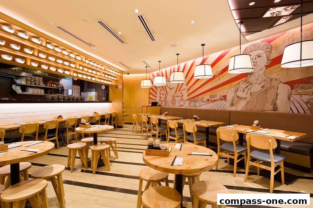 Interior view of LeNu Chefs Wai Noodle Bar with wooden tables, chairs, and a mural.