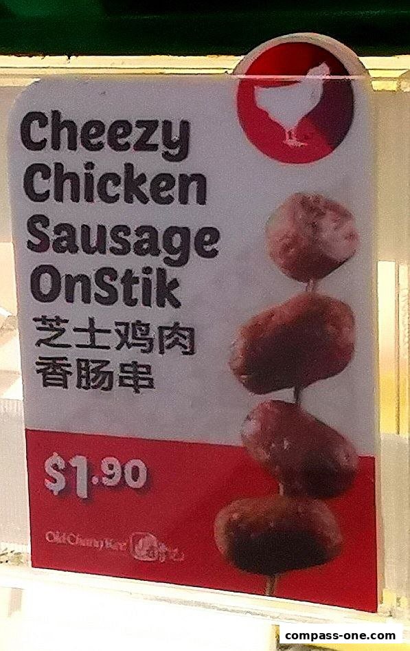 A sign advertising Old Chang Kee's Cheezy Chicken Sausage OnStik for $1.90.