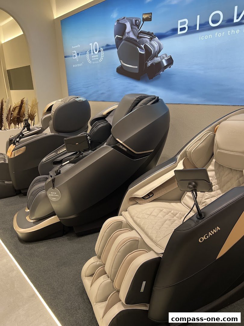 Several OGAWA massage chairs are displayed in a modern, well-lit retail space.