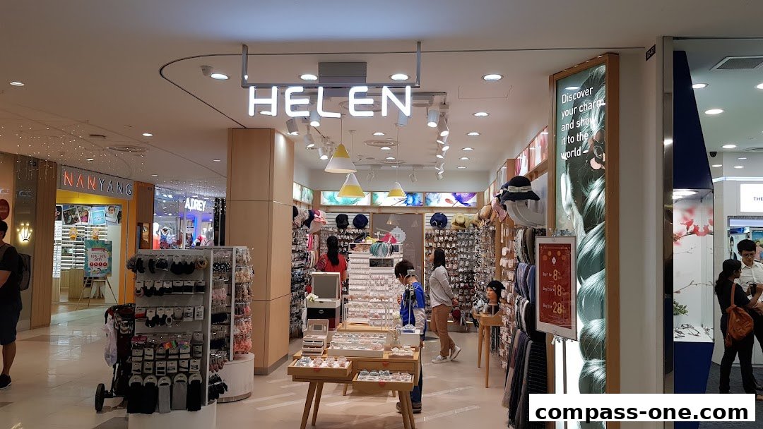 Interior view of a brightly lit fashion accessories shop with various items on display.