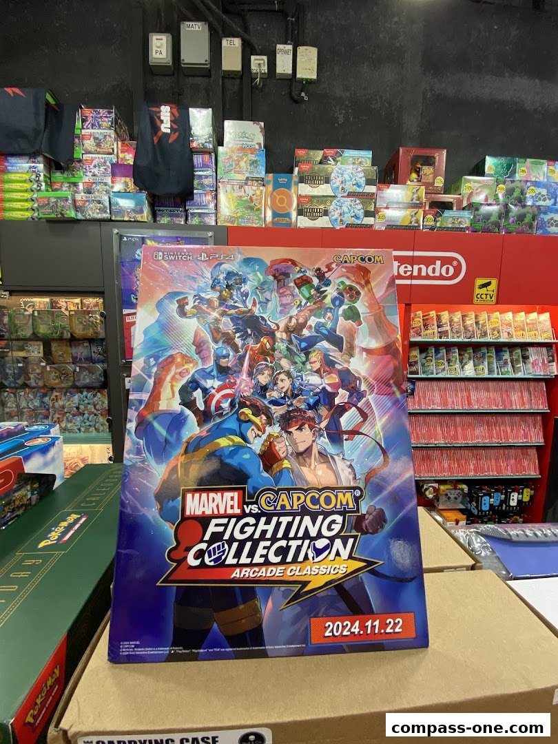 A display of video games and merchandise, featuring a Marvel vs. Capcom Fighting Collection poster.